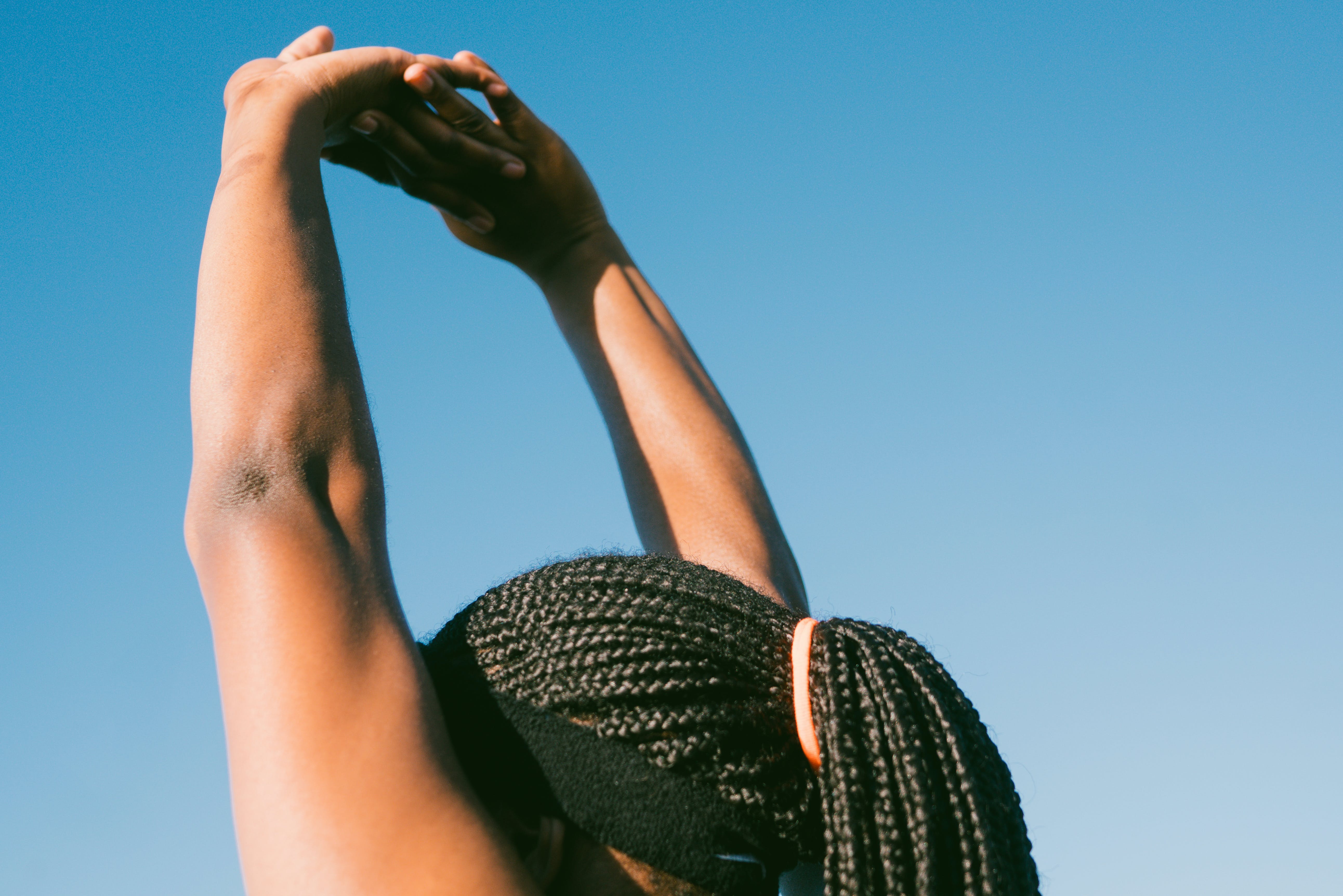 girl with braids and arms outstretched